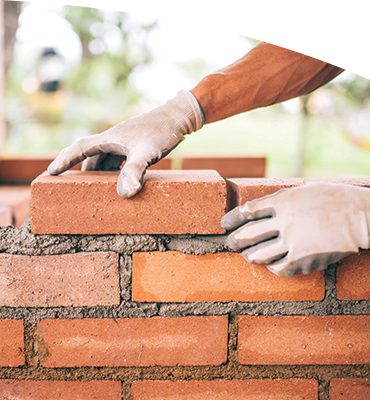 Man building a brick wall