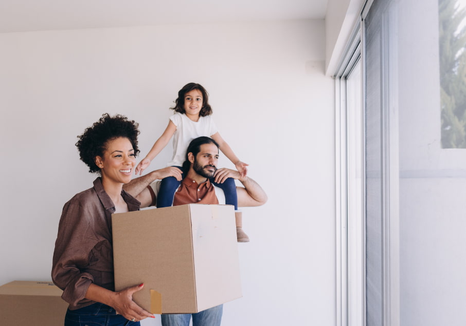 man, woman, and girl moving into a new house
