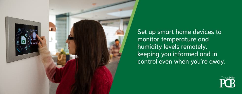 A person adjusting the thermostat