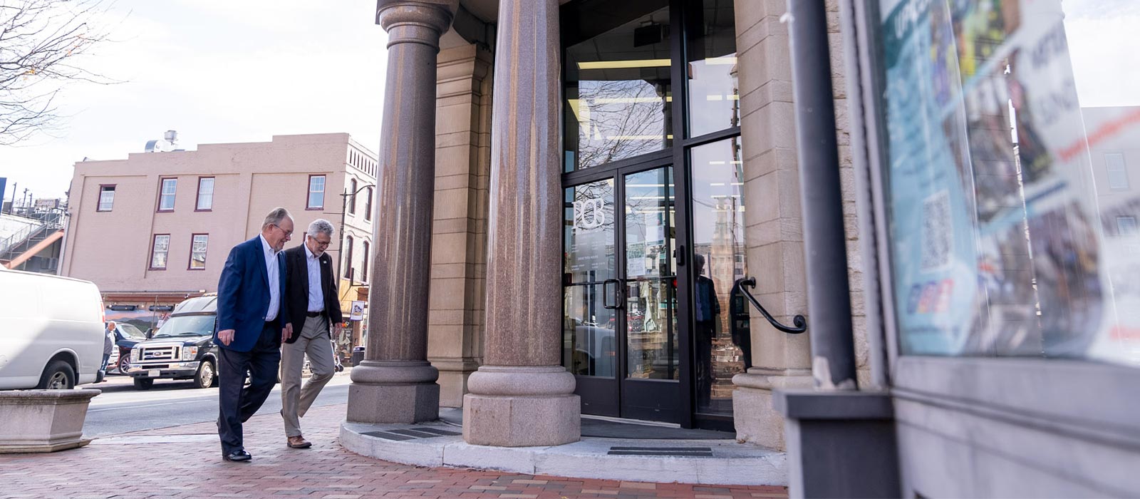Two people walking into the bank