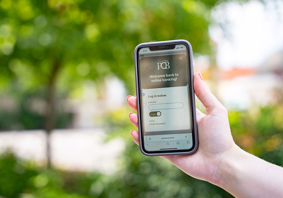 A hand holding a mobile device 