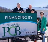 Group of people with PCB financing by sign