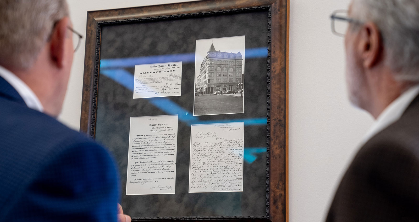 Two people looking at historical images
