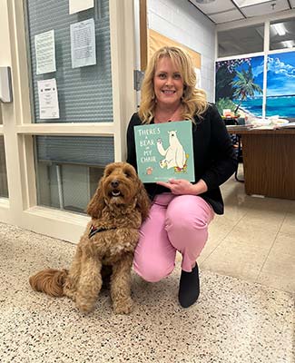 Volunteer reading at elementary school