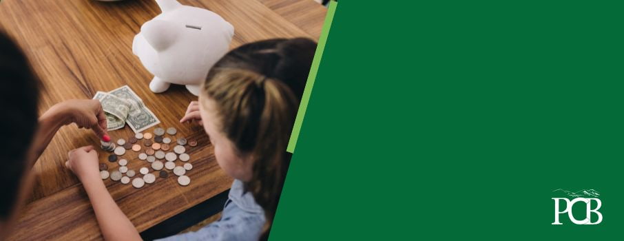 A child counting money from a piggy bank