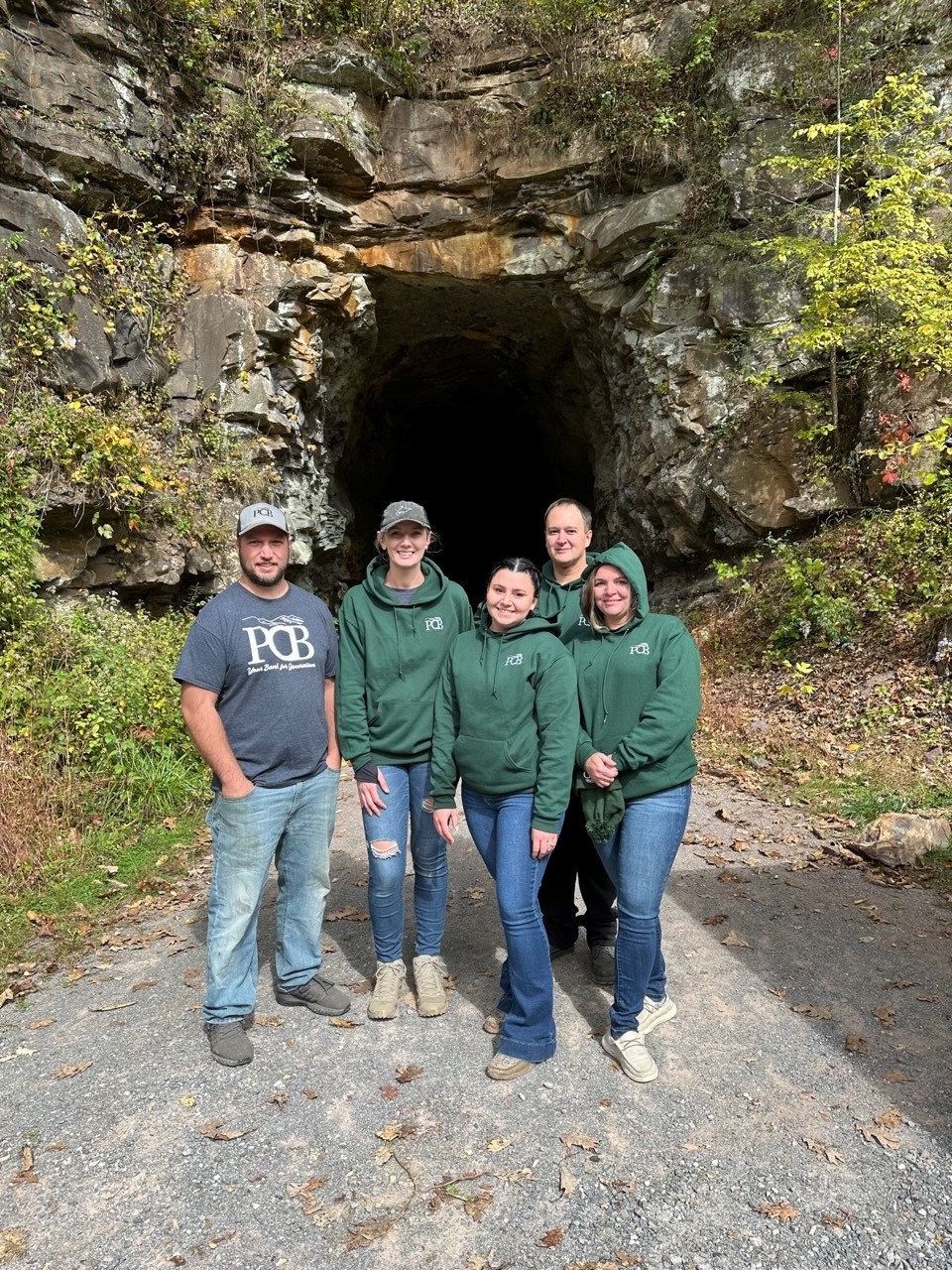 5 Marlinton PCB employees stand outside a cave. 