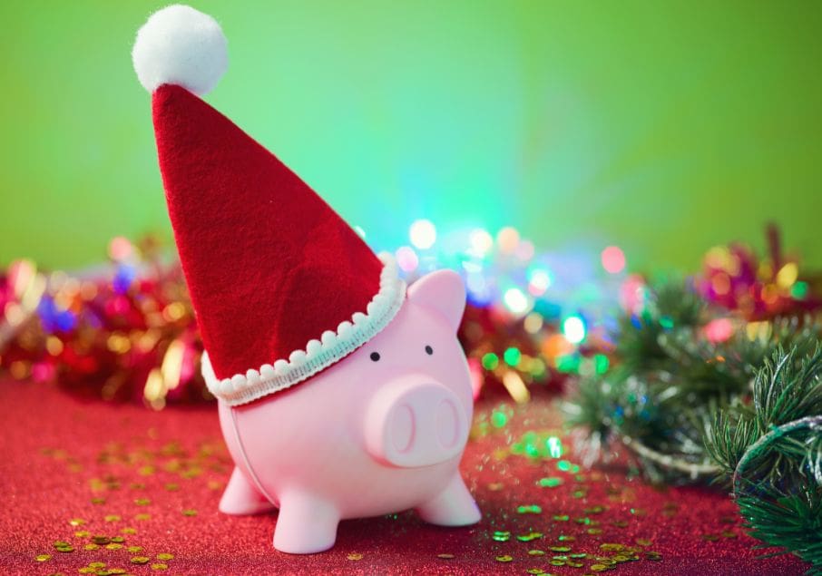 A piggy bank wearing a santa hat