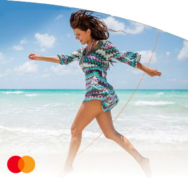 Woman walking on a beach. Mastercard Priceless promotion
